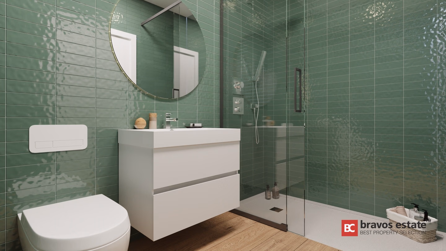 CGI render of a Bonalba Green apartment bathroom featuring glossy green subway tiles, a wall-hung toilet, floating white vanity, round gold-framed mirror, and glass walk-in shower.